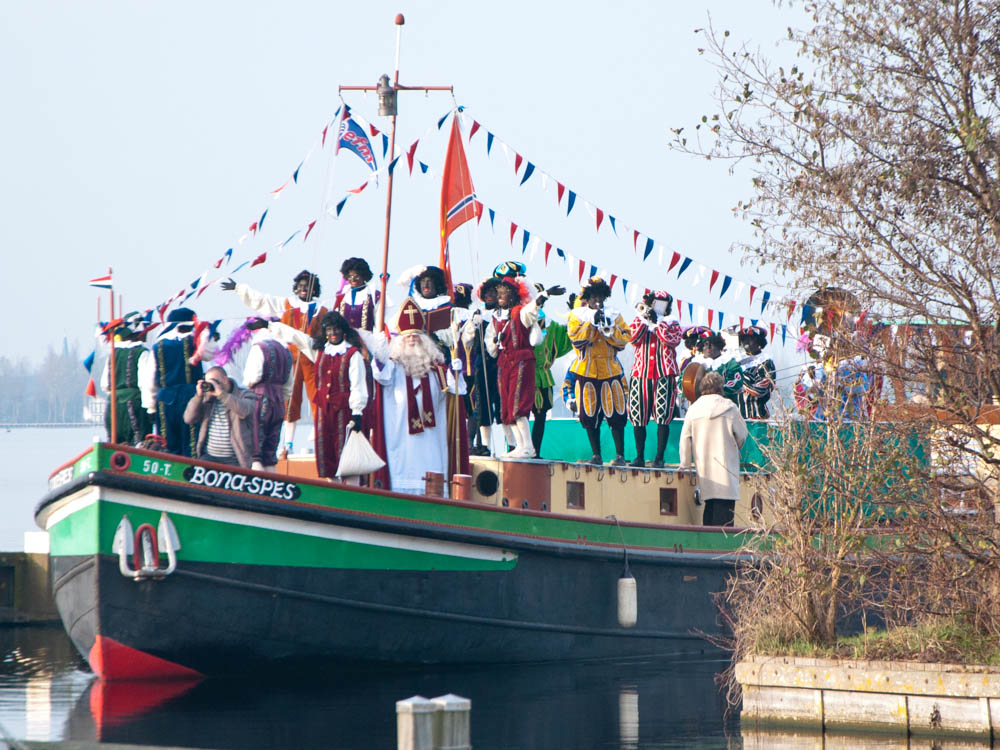 Sinterklaas and his Black Petes arriving on their steam boat