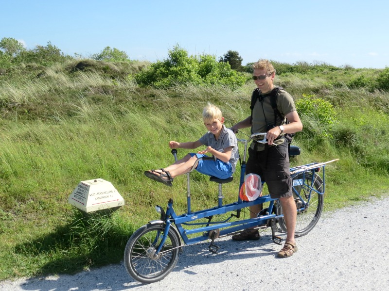 Patrick with his son on a tandem in the Dutch dunes
