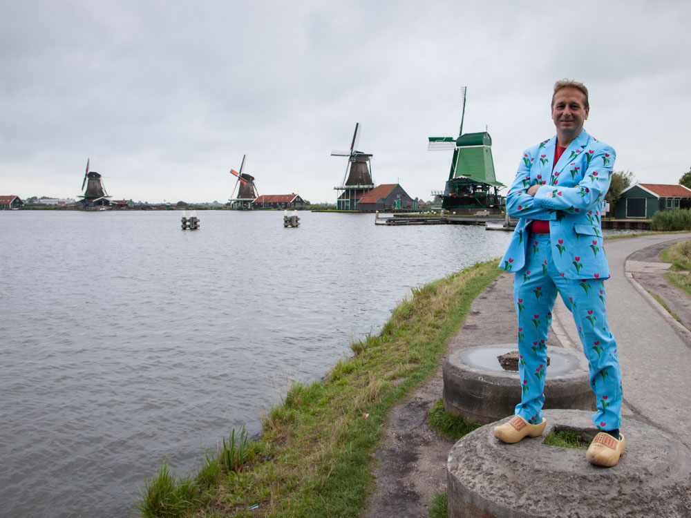Man standing with Dutch windmills in the background